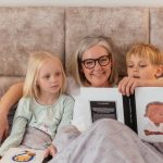 A grandmother reads bedtime stories to her two grandchildren, creating a warm family bond.